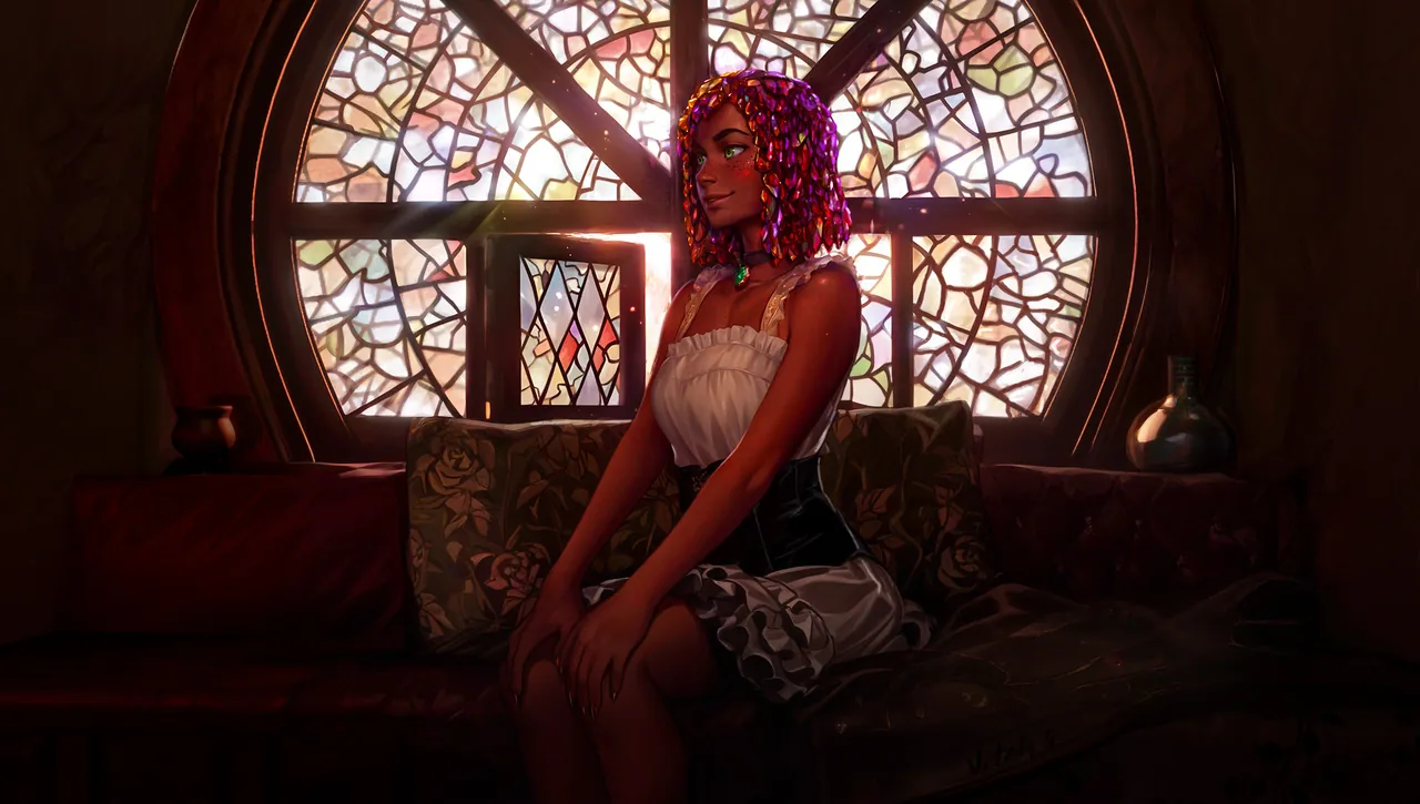 Kliss sits on a floral sofa in front of a large, arched stained-glass window.